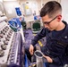 USS America Sailor reviews work of embroider machine