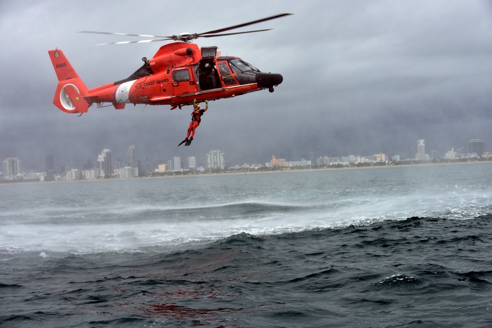 Coast Guard rescue swimmer conducts free fall deployment from helicopter