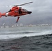 Coast Guard rescue swimmer conducts free fall deployment from helicopter