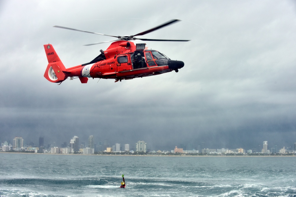 Coast Guard rescue swimmer signals okay after free fall deployment