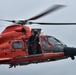 Coast Guard helicopter mechanic prepares for hoist