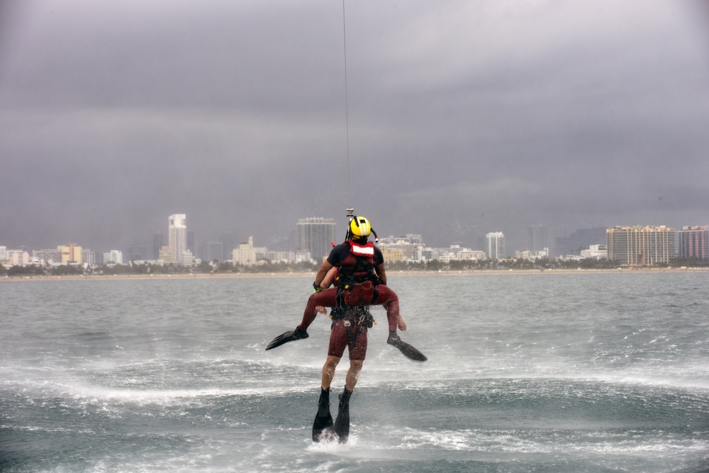 Coast Guard rescue swimmer and Jim Cantore get hoisted off Miami Beach