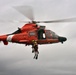 Coast Guard rescue swimmer and Jim Cantore hoisted by helicopter off Miami Beach