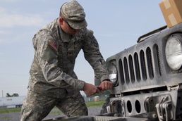 Mechanic Replaces Humvee Headlight