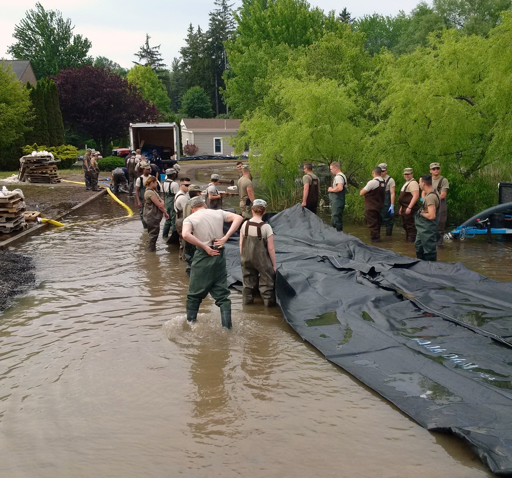 NY Army Guard Soldiers deploy water filled dam to control flooding