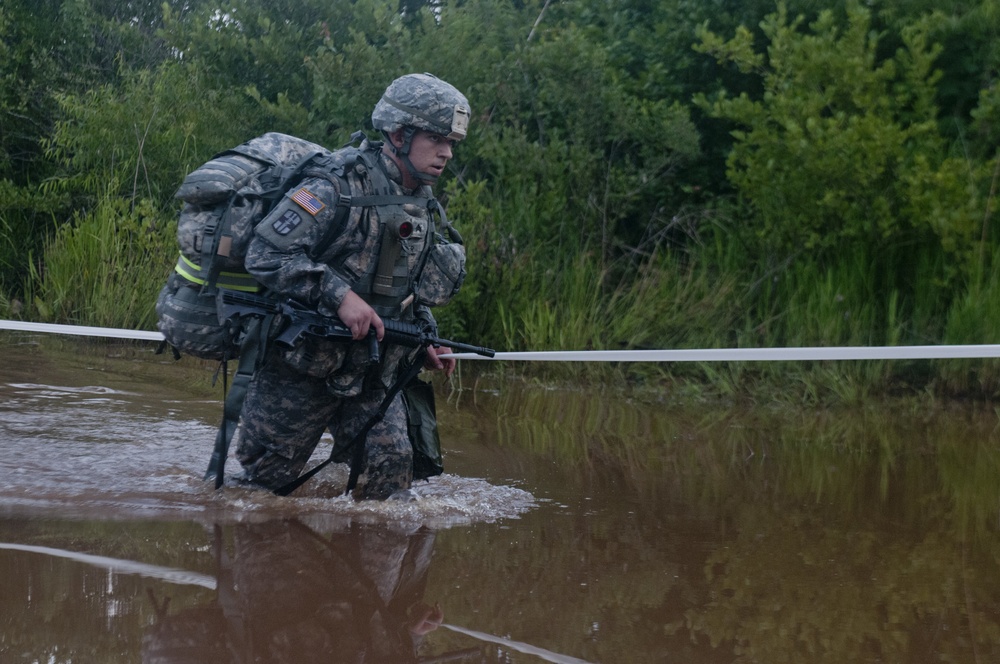 Warrior Crosses Water During Ruck March