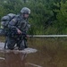 Warrior Crosses Water During Ruck March