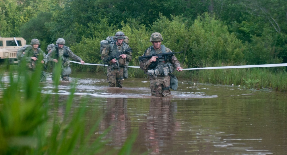 Warriors Cross Water During Ruck March