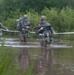 Warriors Cross Water During Ruck March