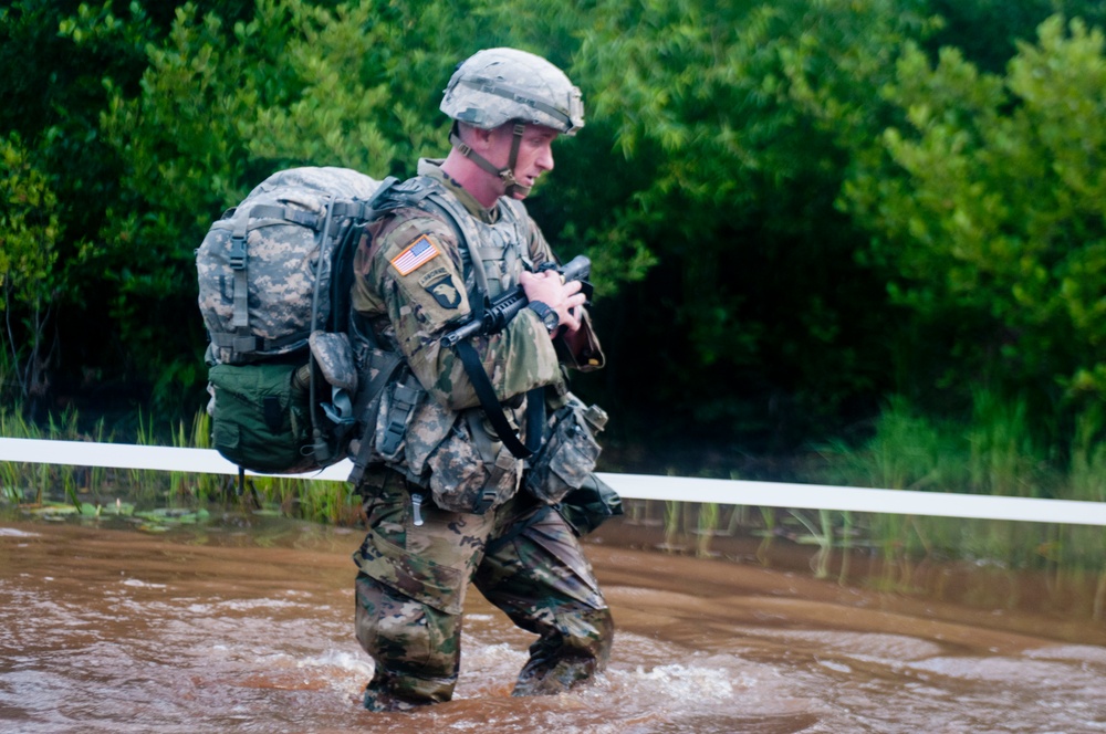 Warrior Crosses Water During Ruck March