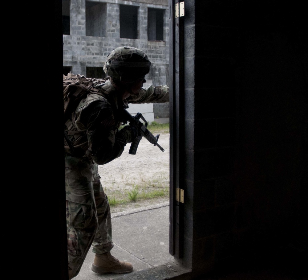 Soldier Maneuvers Through Village