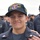 170525-N-CF105-185 A young U.S. Navy sailor named Peter D. Mims is pictured wearing a USS Shiloh CG-67 cap and Navy working uniform. He is holding a Department of the Navy document dated 24 May 17 (May 24, 2017), and another person's hand is visible on his shoulder, suggesting a recognition or promotion ceremony. Other sailors in similar uniforms are visible in the background.