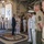 170613-N-FM530-011 A formal military reception or greeting ceremony is taking place aboard the USS Mesa Verde (LPD-19), a U.S. Navy amphibious transport dock ship. A civilian in a dark suit is being greeted by naval and Marine Corps officers and enlisted personnel in various dress uniforms. The scene appears to be an official dignitary visit or inspection at the ship's quarterdeck.