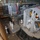 170613-N-FM530-044 The image shows the well deck of a naval amphibious ship, likely a US Navy vessel, containing at least two Landing Craft Air Cushion (LCAC) hovercraft. Military personnel in white dress uniforms, camouflage utilities, and civilian attire are conducting what appears to be an official inspection or tour. The large circular shrouded propellers of the LCACs are prominently visible, with red 'PROPELLER' warning labels clearly legible.