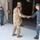 170615-N-NY430-0127 The image shows a military inter-service meeting at what appears to be a warehouse or hangar facility. A U.S. Army soldier in OCP (Operational Camouflage Pattern) uniform is shaking hands with a U.S. Navy sailor in NWU (Navy Working Uniform) Type I blue digital camouflage. A second Army soldier stands in the background while another Navy sailor renders a salute near a doorway.