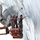 USS Blue Ridge Sailors give the ship a new coat of paint Two workers in safety harnesses and blue hard hats are standing on an orange aerial lift platform, performing maintenance work on the hull of a large ship. They are using long-handled tools to clean or paint the vessel's exterior surface near the stern, where a large ship propeller is prominently visible. The image is taken from a low angle, emphasizing the scale of the ship and the height of the work being performed.