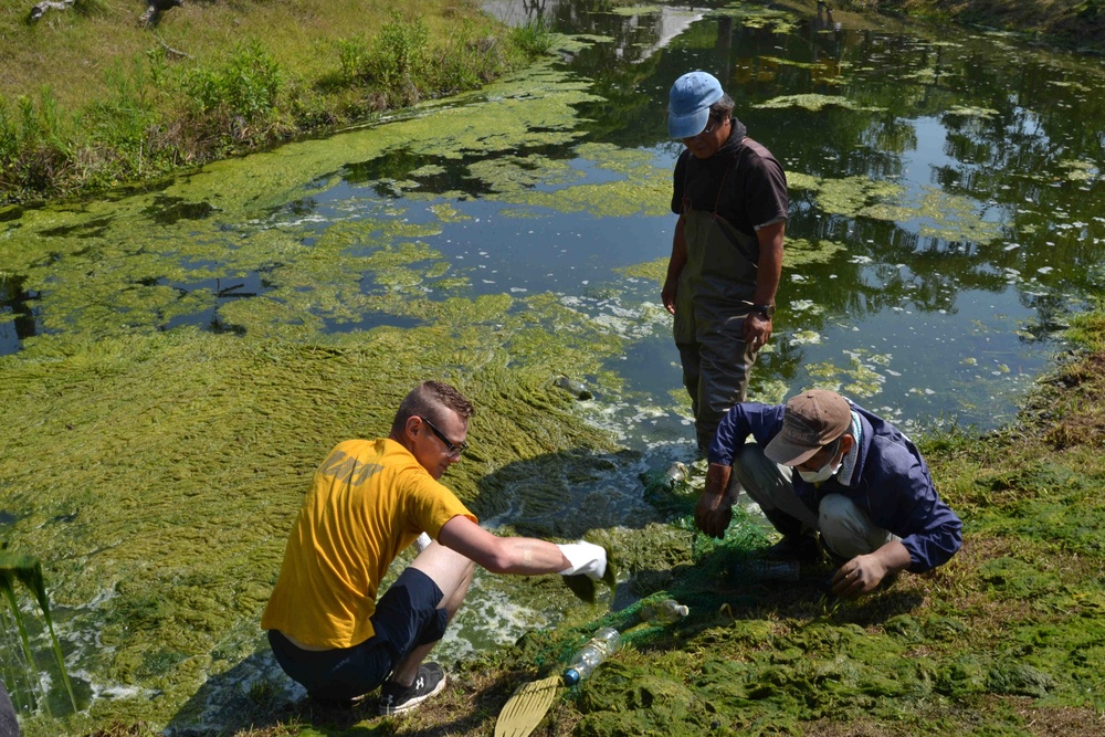 Sailors work with the Sasebo community to clean a zoo