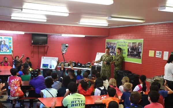 Sailors talk to children at the Shadyside Boys and Girl Club