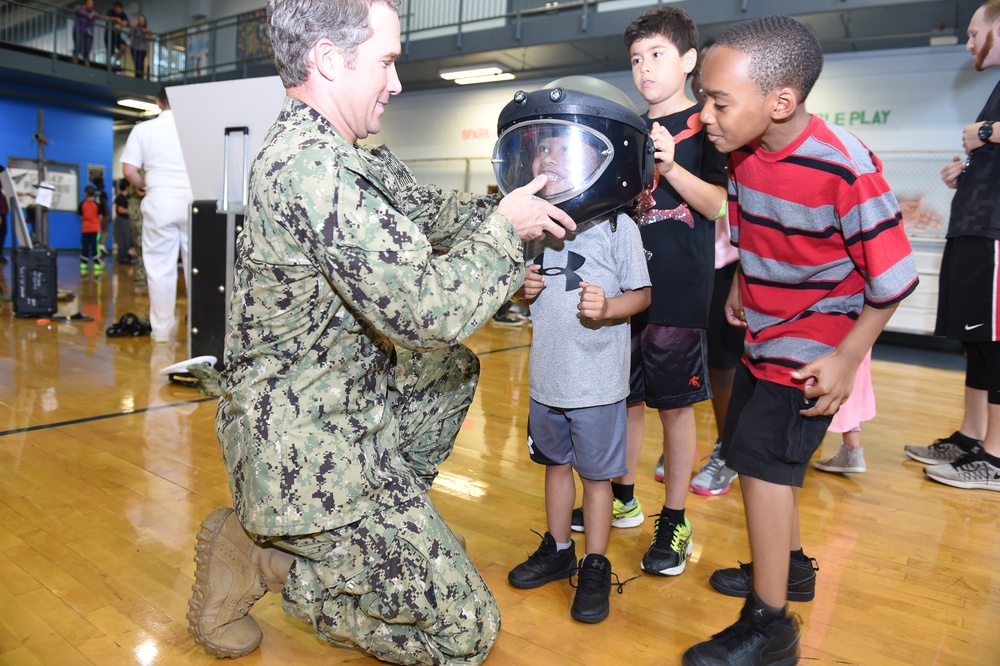 Children try on a bomb helmet