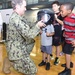 Children try on a bomb helmet