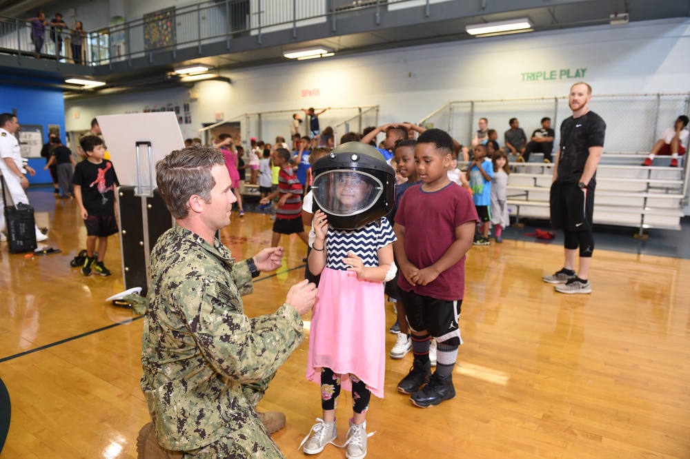 Children try on bomb helmet