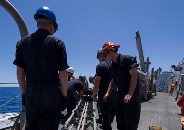 Sailors Load a MK 46 torpedo aboard USS Shoup