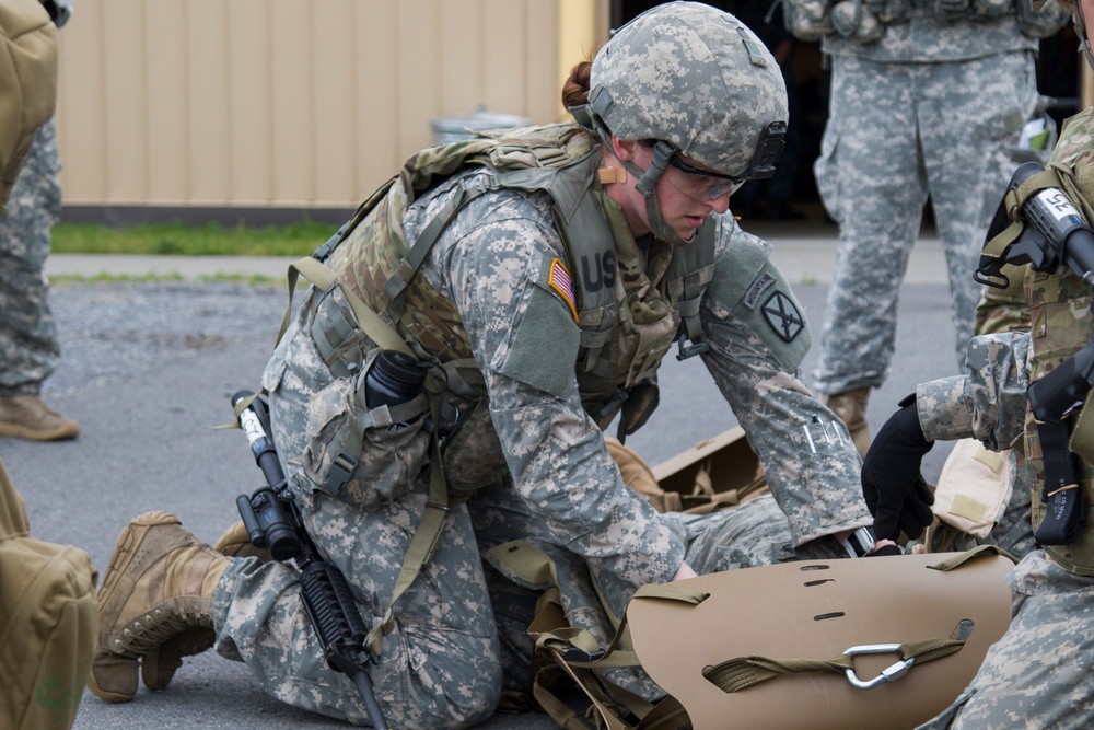 Soldier Assesses Simulated Casualty