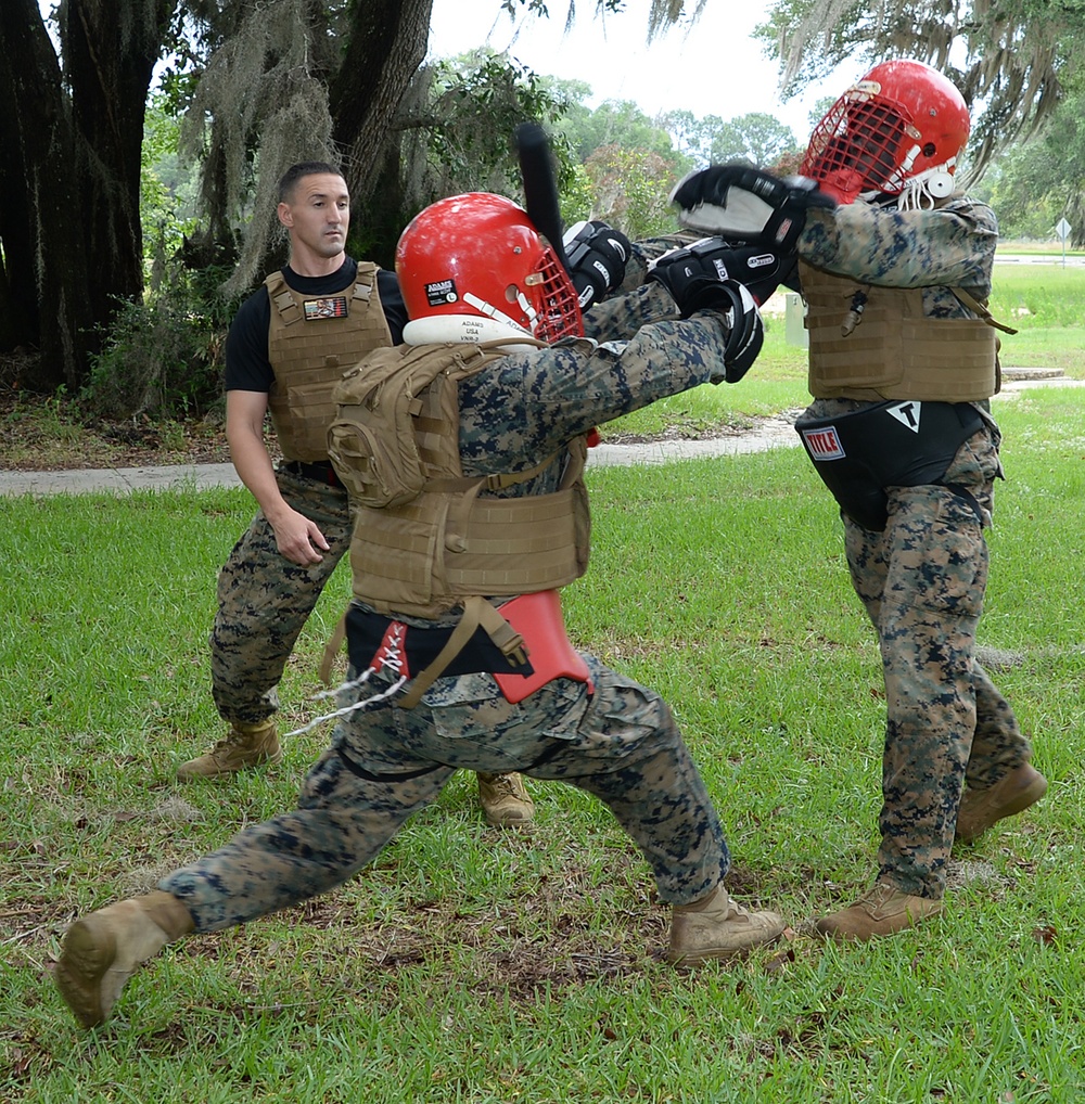 Sgt. Frederick Graham, right, martial arts instructor course student, Marine Corps Logistics Base Albany, round kicks the pad of Sgt. Salvador Hernandez during a Martial Arts Instructor Course aboard Marine Corps Logistics Base Albany, May 24.