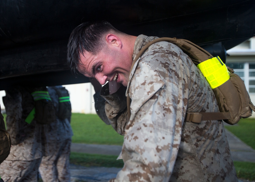 Marines conduct physical training with a combat rubber raiding craft