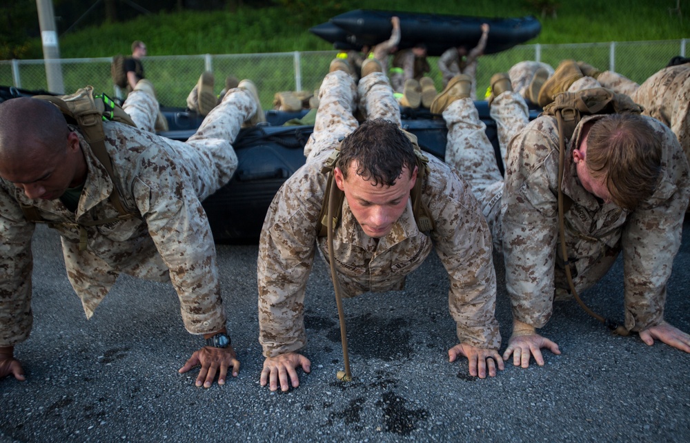 Marines conduct physical training with a combat rubber raiding craft