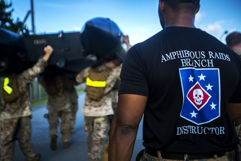 Marines conduct physical training with a combat rubber raiding craft