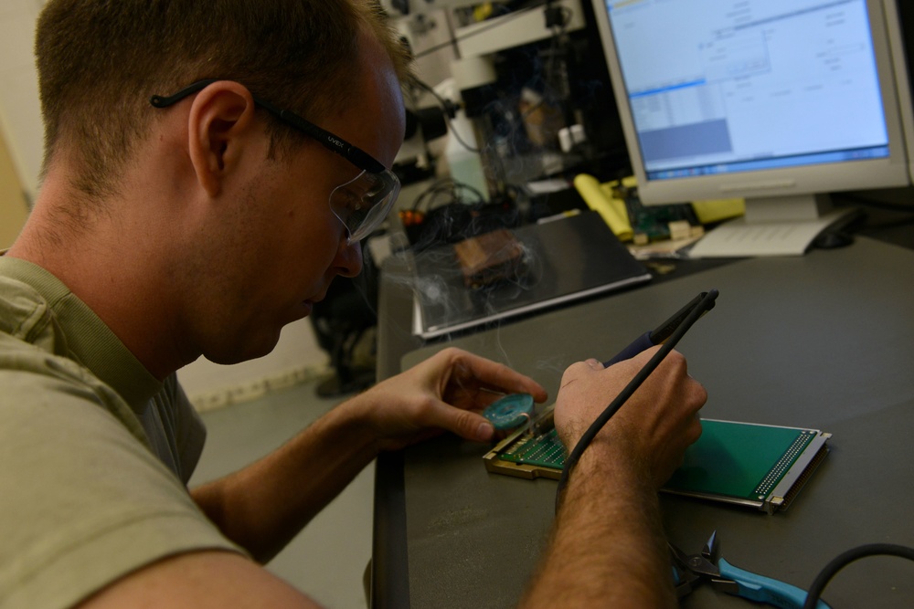 AFREP Airman fixes circuit board