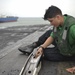 Sailor Cleans Catapult System