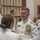 Marine Barracks Washington; EveningParade July 14, 2017 A formal military ceremony or reception featuring personnel in white dress uniforms adorned with medals, ribbons, and gold insignia. A senior officer with an extensive array of medals and decorations is engaged in conversation with another uniformed individual whose back is to the camera. The setting appears to be an indoor formal venue with multiple military and civilian attendees in the background.