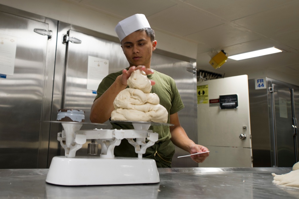 USS America Sailor prepares sweet rolls