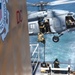 Navy helicopters deploy Coast Guard members onto Coast Guard cutter