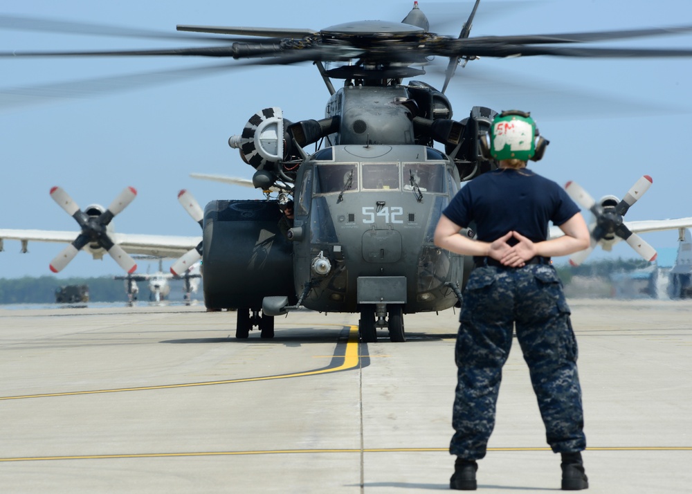 Sailor prepares to signal MH-53