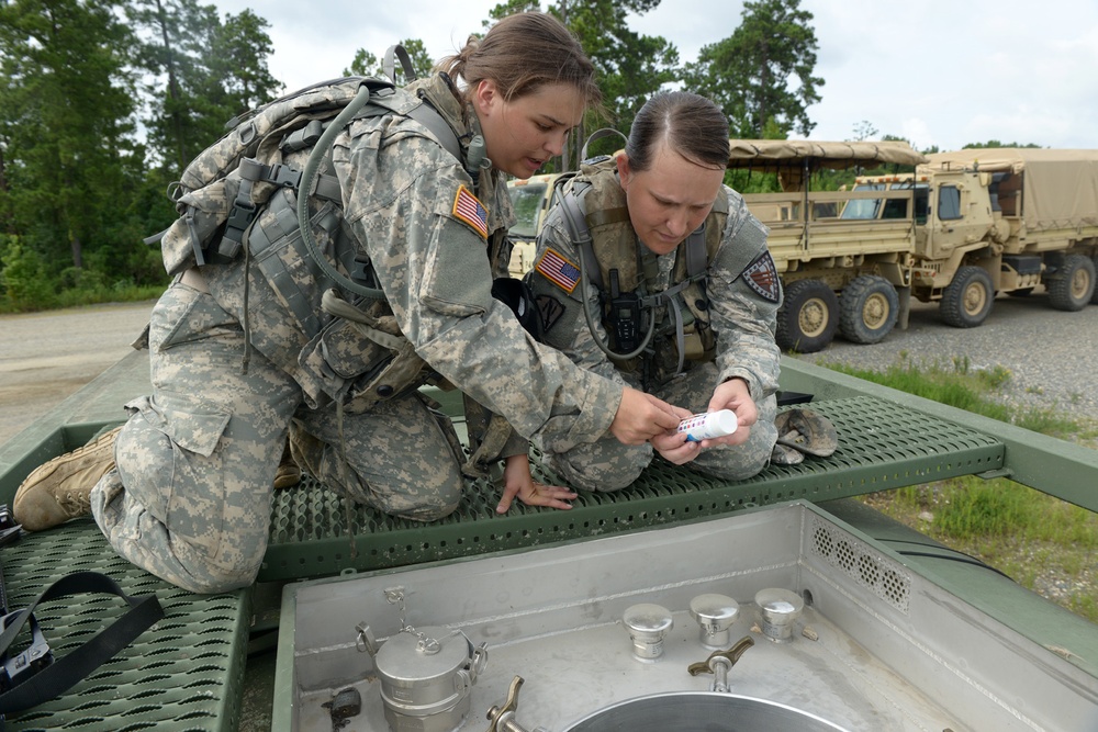 Soldiers with 138th Quartermaster bear water to keep 76th troops hydrated