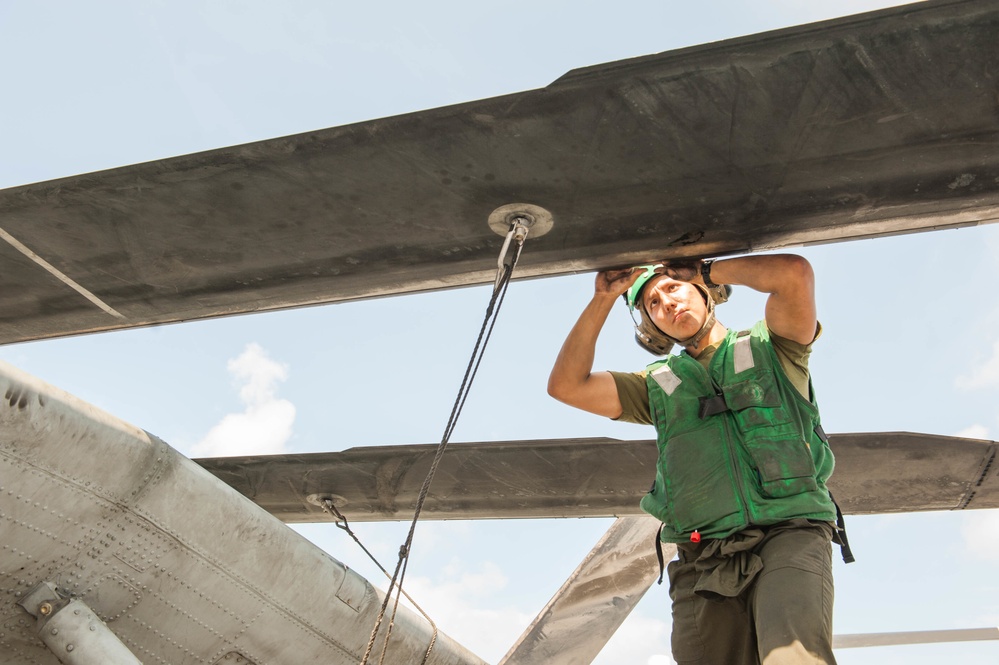 USS America Marine does maintenance on CH53E Super Stallion