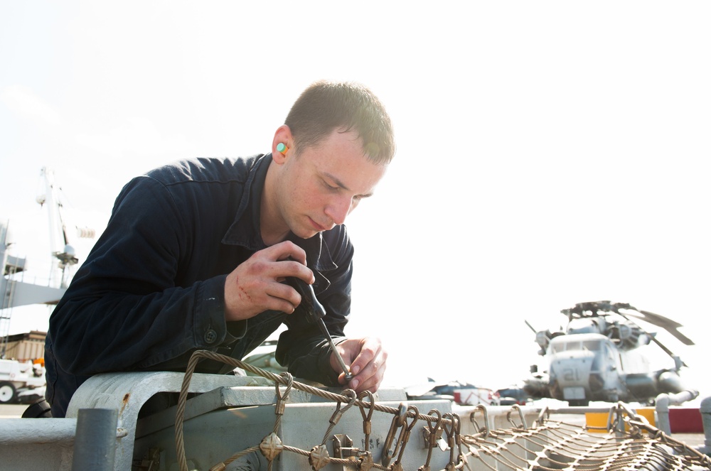 USS America Sailor conducts maintenance