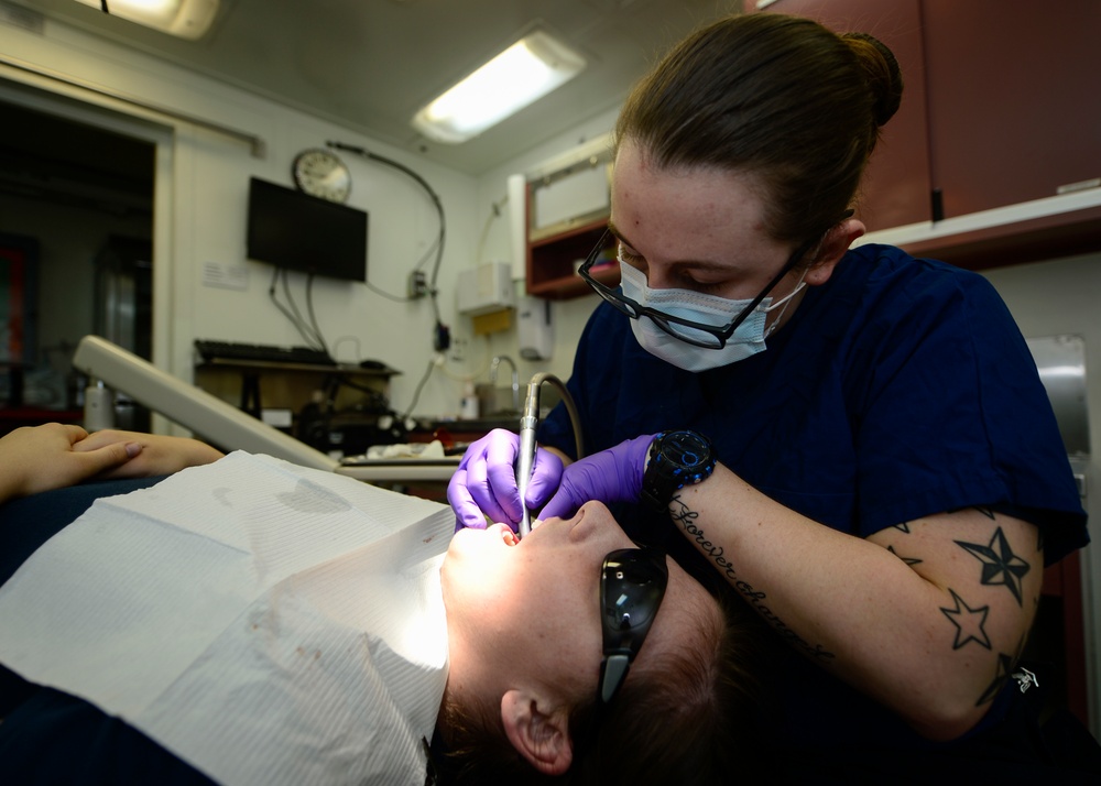 Sailor Performs Teeth Cleaning