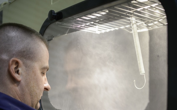 Sandblasting MAAS components.