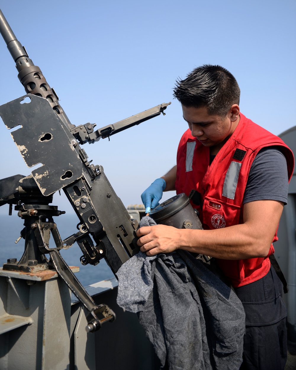 Sailor Cleans .50 Caliber Machine Gun