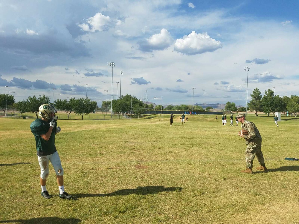 Phoenix recruiter makes impact as high school football coach