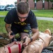 Staff Sgt. Jonathan Anderson practices applying a tourniquet