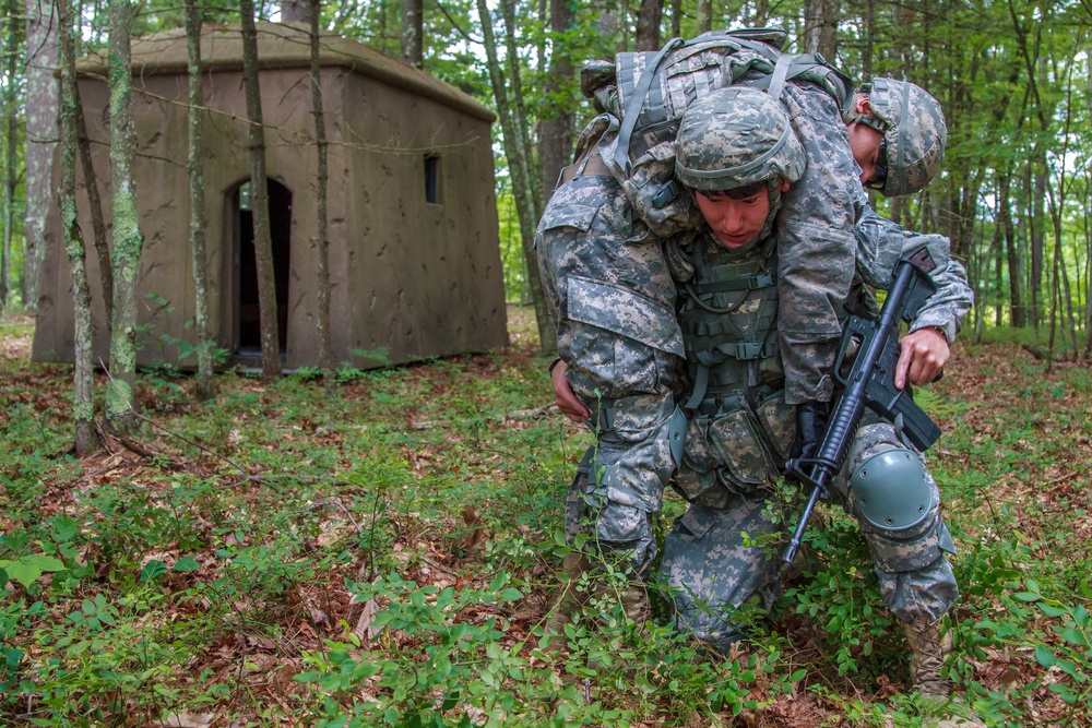 Spc. Wantea Seong carries Spc. Kenny Ochoa to safety