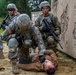 Spc. Kenny Ochoa,provides treatment while Spc. Wantea Seong and Cpl. Carlo Deldonno provide security
