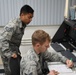 Staff Sgt. Andrew Tymczyszyn and Staff Sgt. Kevin De Guzman working in the 146AW Command Post