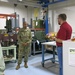 Letterkenny Munitions Center employee, Josh Shaul, provides an overview of Multiple Launch Rocket System Family of Munitions (MFOM) electronics and wiring activities to Lt. Gen. Piggee.