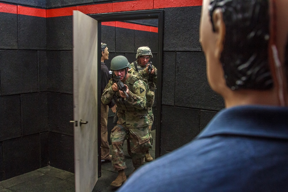 Cpl. Carlo Deldonno and Staff Sgt. Jonathan Anderson practice room clearing techniques